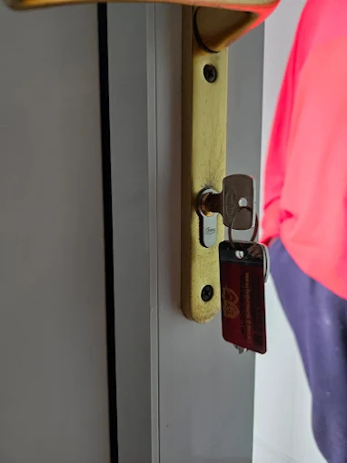 Locksmith handing over new keys on a commercial door in Carlisle
